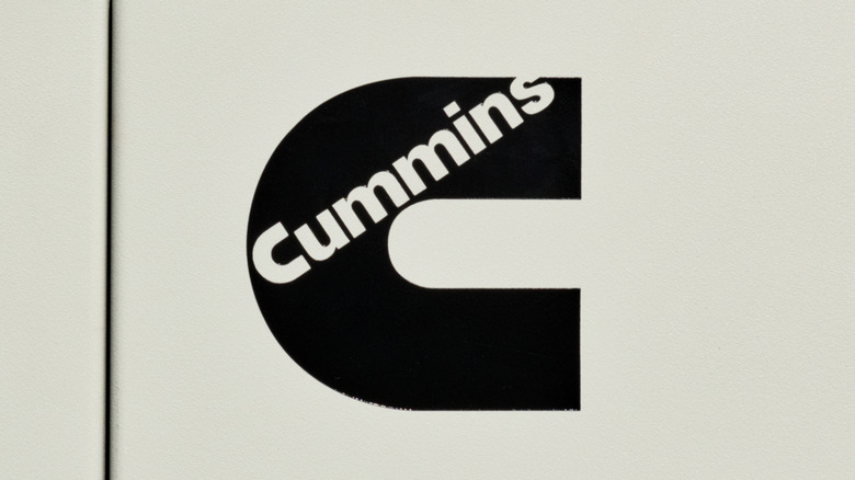 A black Cummins logo on a white surface.