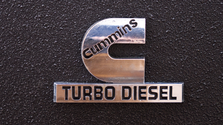 A silver Cummins Turbo Diesel logo on a black background.