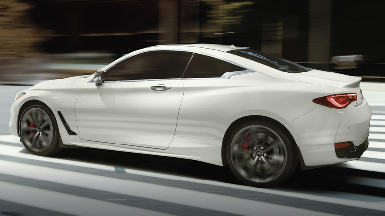 White Infiniti Q60 coupe driving down street