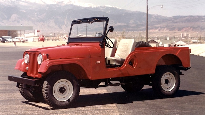 A rust-colored Jeep CJ-6 parked in a parking lot