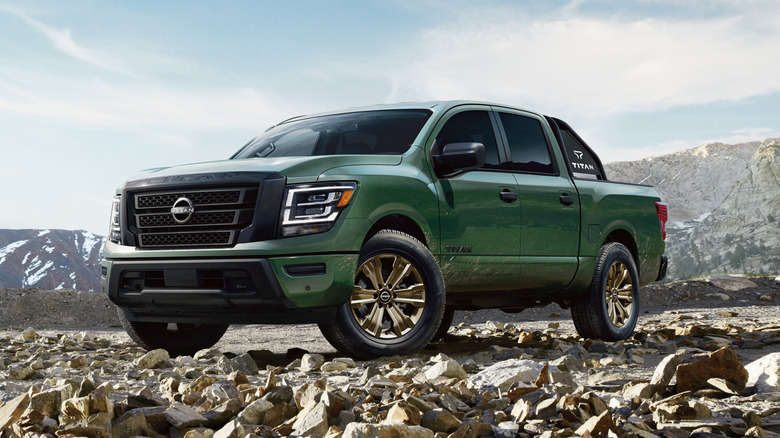 Green 2024 Nissan Titan parked on rocks on a sunny day