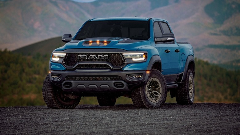 Blue and black 2024 RAM 1500 TRX 6.2L Supercharged V8 - Final Edition parked with mountains in the background