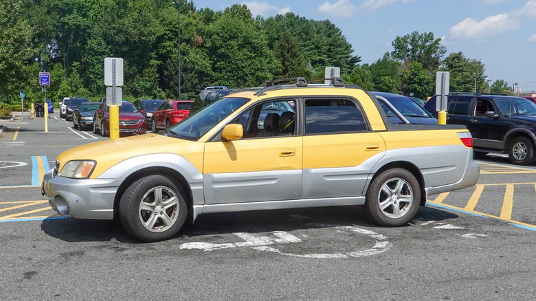 A yellow Subaru Baja in a parking lot