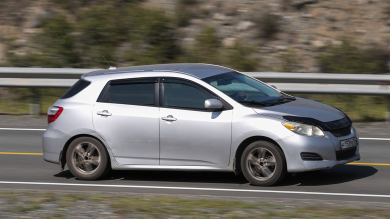 White Toyota Matrix racing down highway