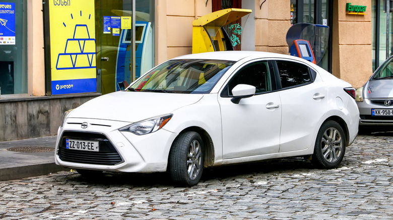 White Scion iA parked on a city street