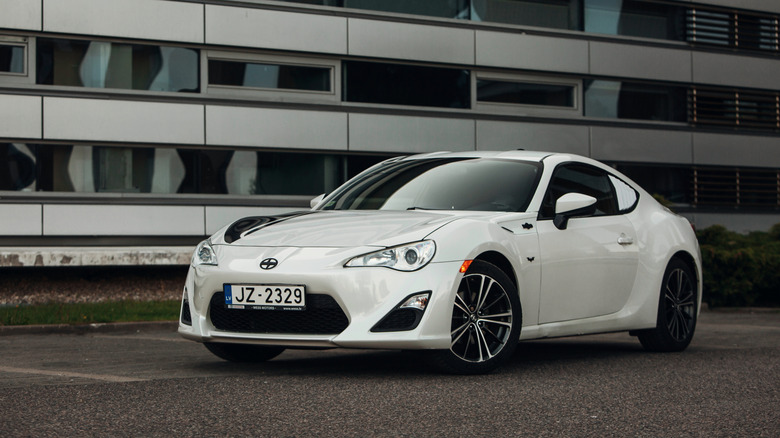 A white Scion FR-S parked on asphalt