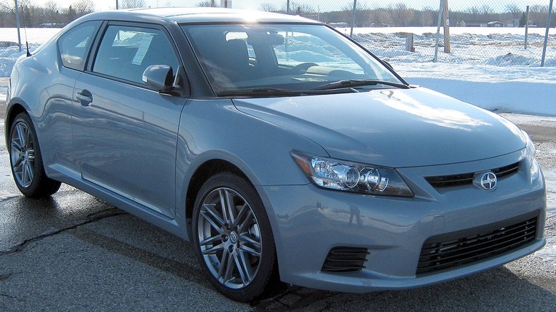 Scion tC parked in lot with snow in background