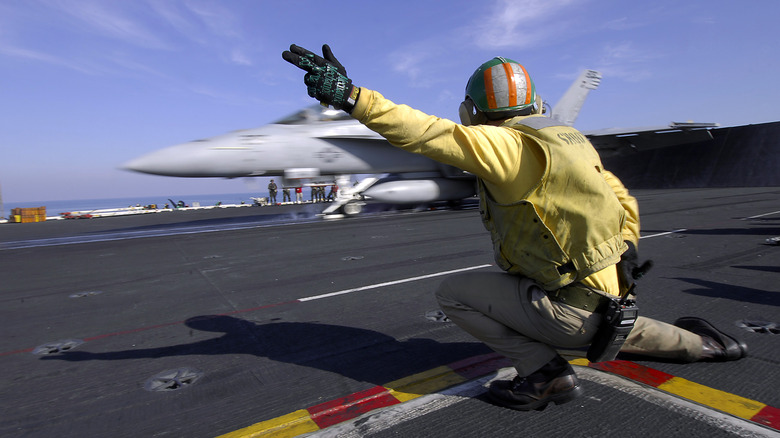 plane taking off aircraft carrier