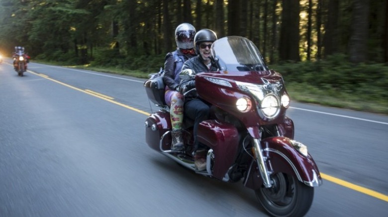 A happy motorcyclist driving on the road