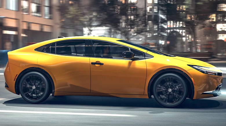 Yellow Toyota Prius driving through a city