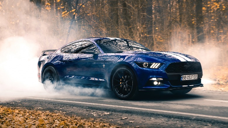 blue Ford Mustang doing a burnout