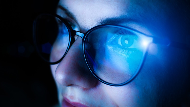 blue light reflecting on glasses