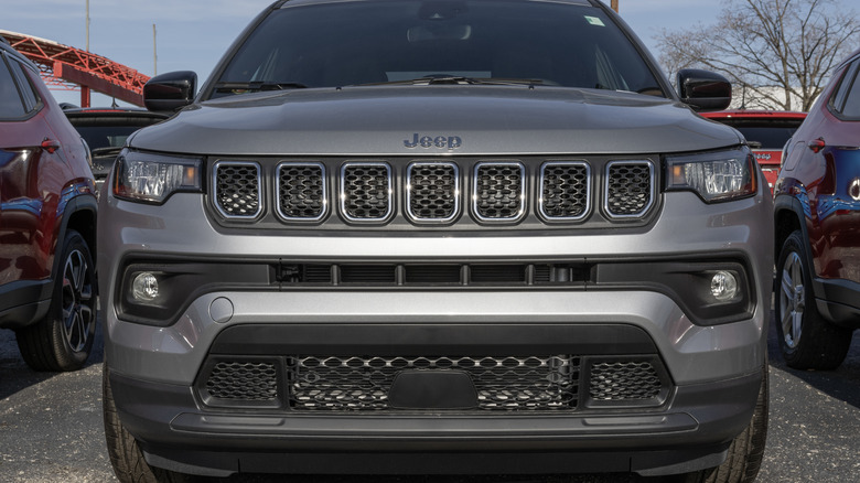 A front view of a 2023 Jeep Compass Latitude displayed at a dealership in Indianapolis shows a modern version of the seven-slot grille.