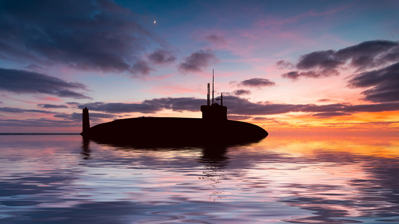 A submarine breaching the surface at dusk