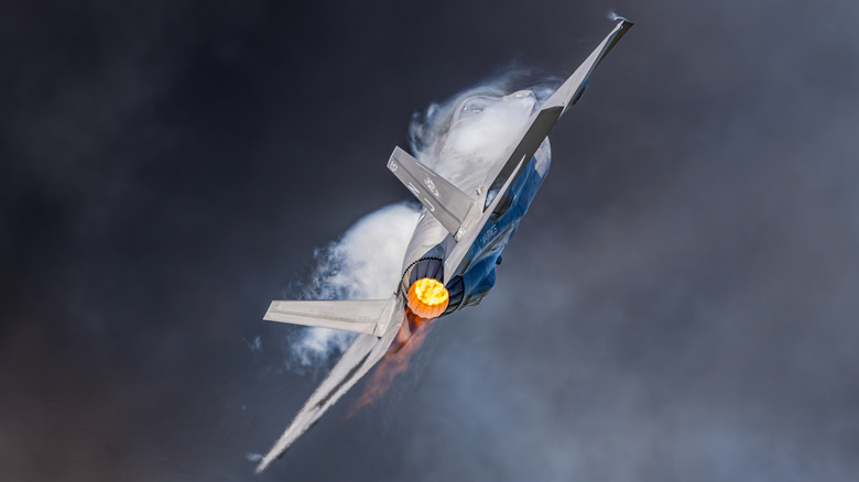 F-35 flying with vapor forming around its fuselage