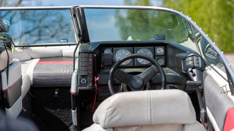 A boat's interior with the steering wheel on the right