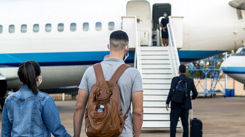 A couple of passengers about to board an airplane