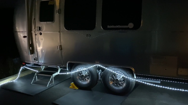 RV Trailer With LED Rope Lights Strung Around the Underside