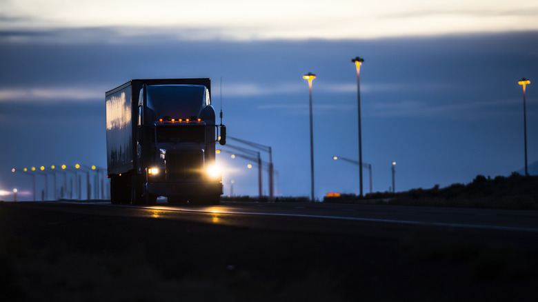 Semi-truck with headlights on