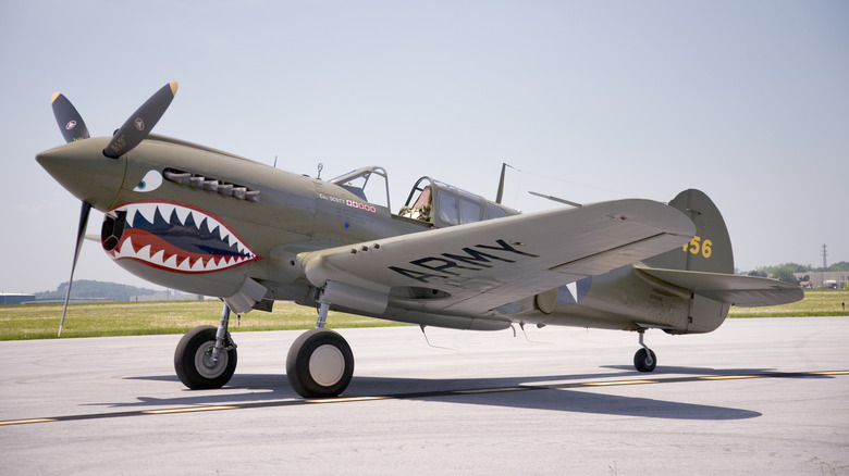 A P-40 with a shark mouth and eyes painted on it.