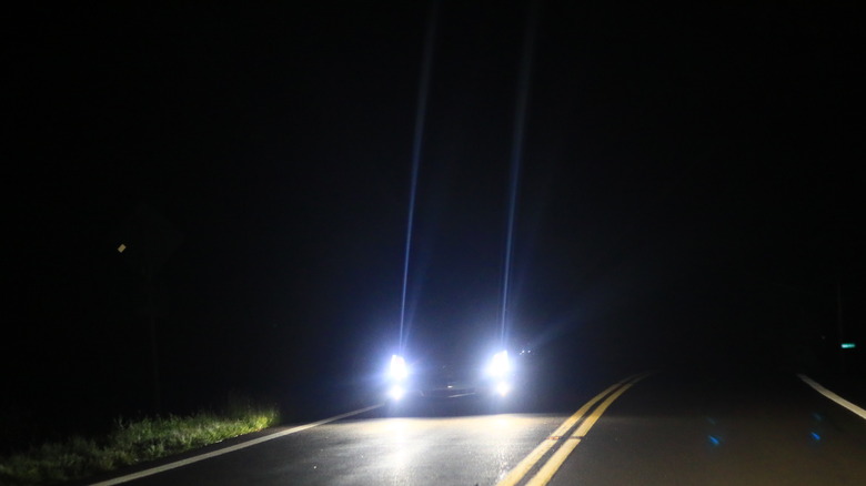 Blue headlights appearing out of the darkness