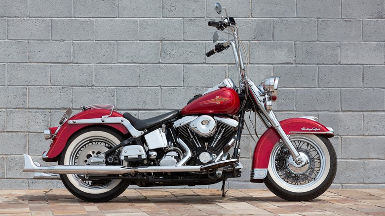 Red Harley Davidson Heritage Softail parked on brick path