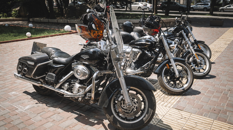 Harley Davidson motorcycles parked in a row on a brick path