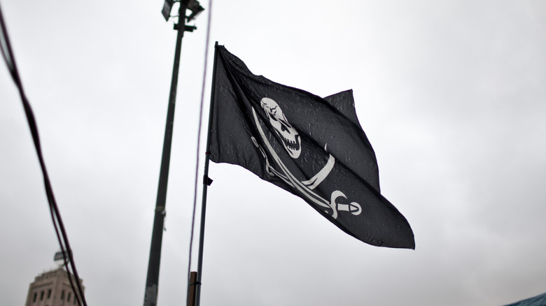 Skull and crossbones flag with an overcast backdrop