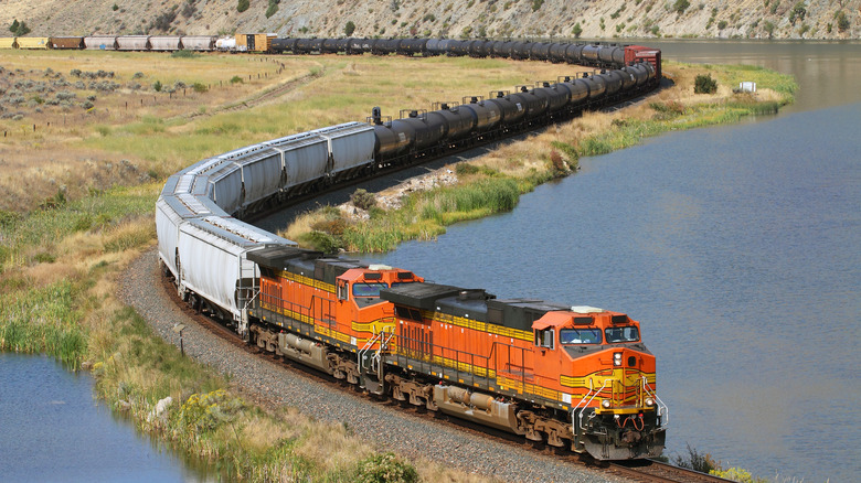 A freight train maneuvering a curve in the U.S. along river