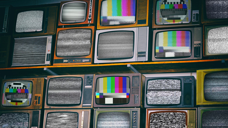 A wall of televisions display technical issues