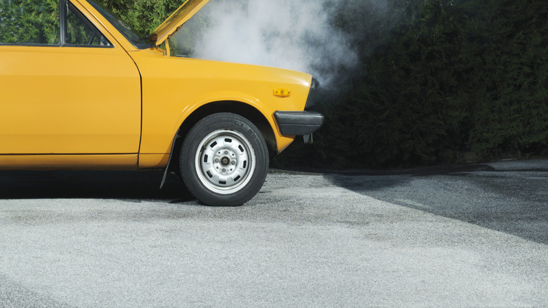 A Broken Down Car With A Smoking Engine