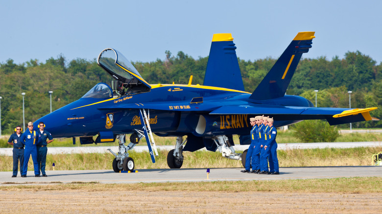 Blue Angels jet on a runway with pilots.