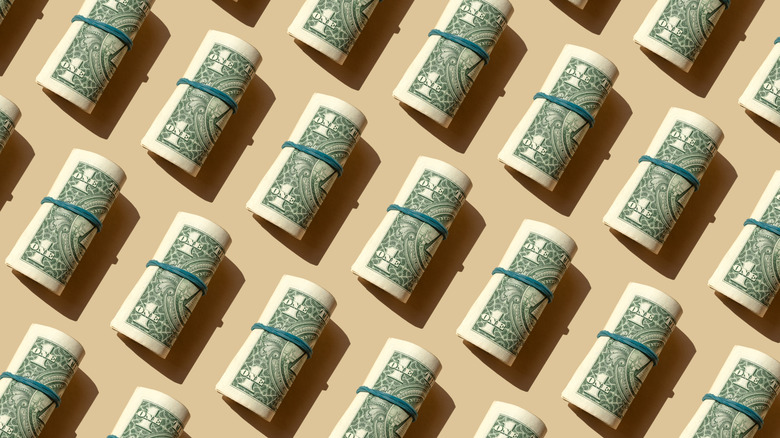 Rolls of $1 bills on a brown background