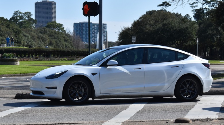 A white Tesla vehicle on road