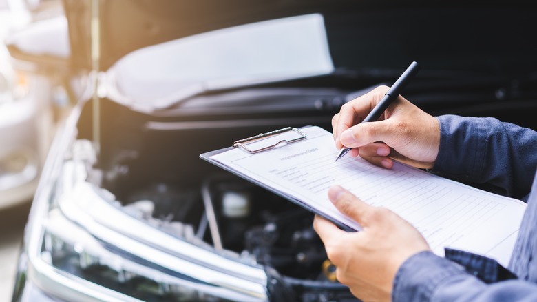 Mechanic checking auto engine