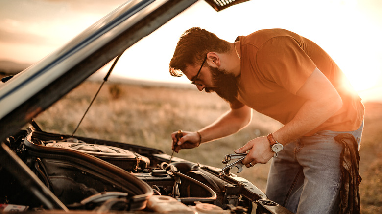 Mechanic checking auto engine