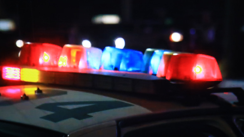 Red and blue lights on top of a police car.