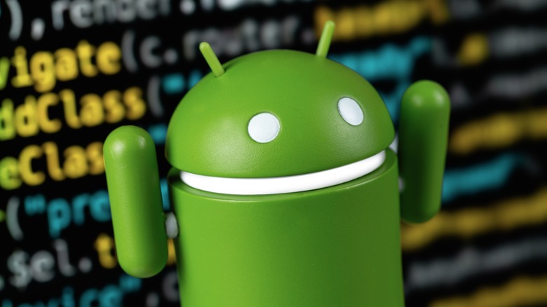 Google Android figure closeup and digital programming code background