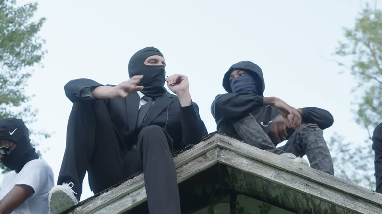 members of Kia Boys on roof doing interview