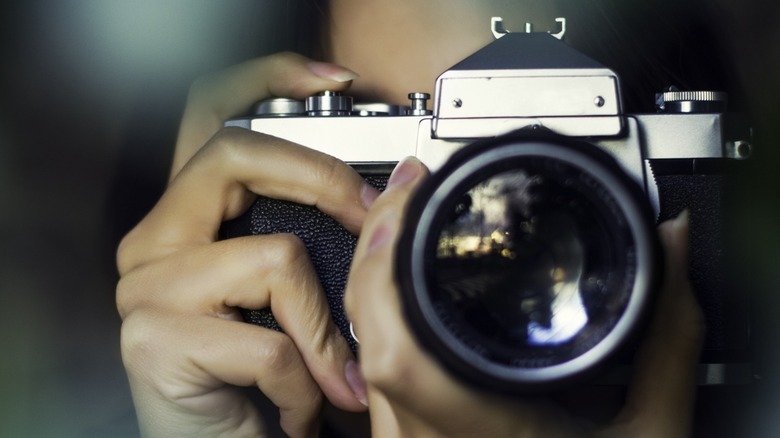 a photographer holding a camera