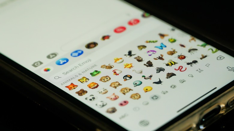 An iPhone screen displaying the iOS emoji keyboard.