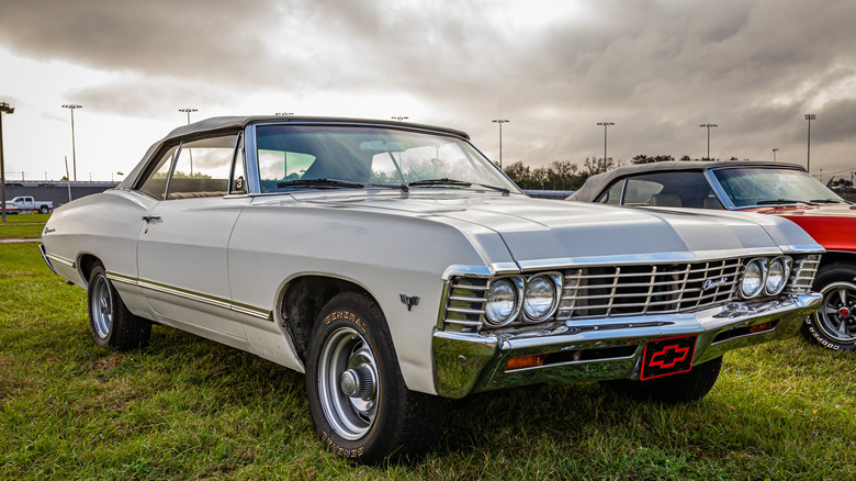 1967 Chevy Impala parked on grass