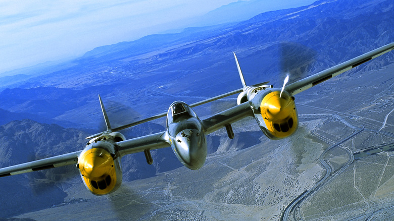 P-38 Lightning flying over mountains