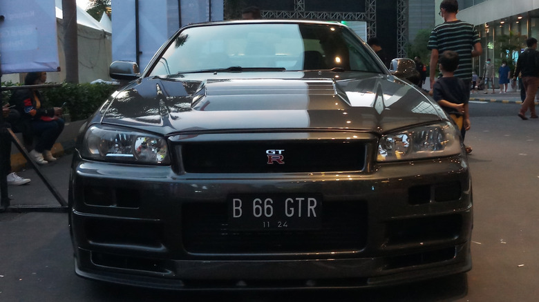 A Nissan Skyline GT-R parked in a city.