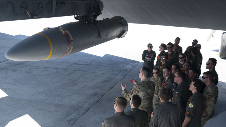 U.S. Air Force personnel look at a hypersonic missile.