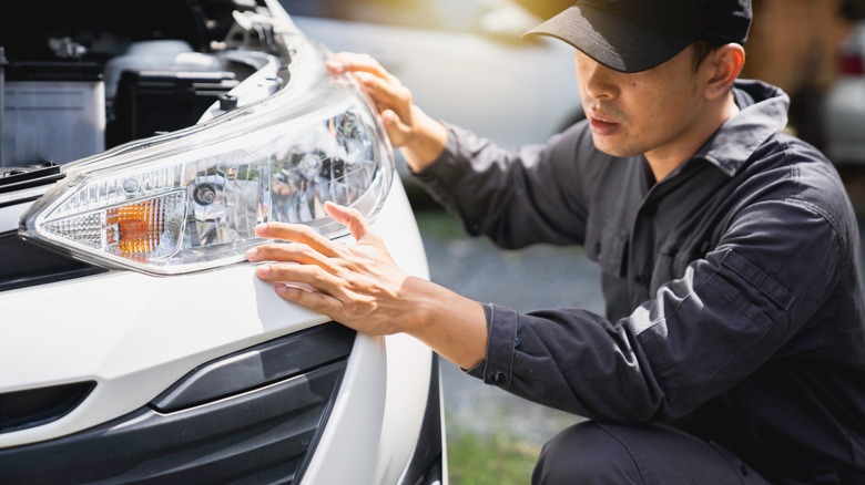 Mechanic installing headlight