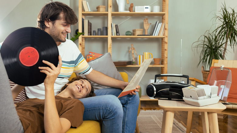 Man and woman listening to records