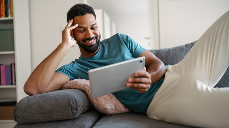 man watching videos on a tablet