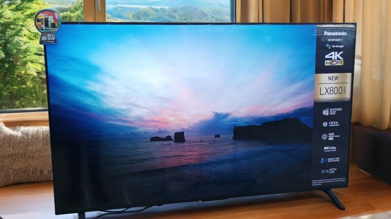 A 4K HDR Panasonic television placed on the floor of a living room