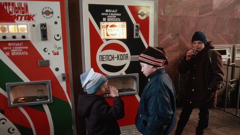 Russian children drink from a Pepsi vending machine